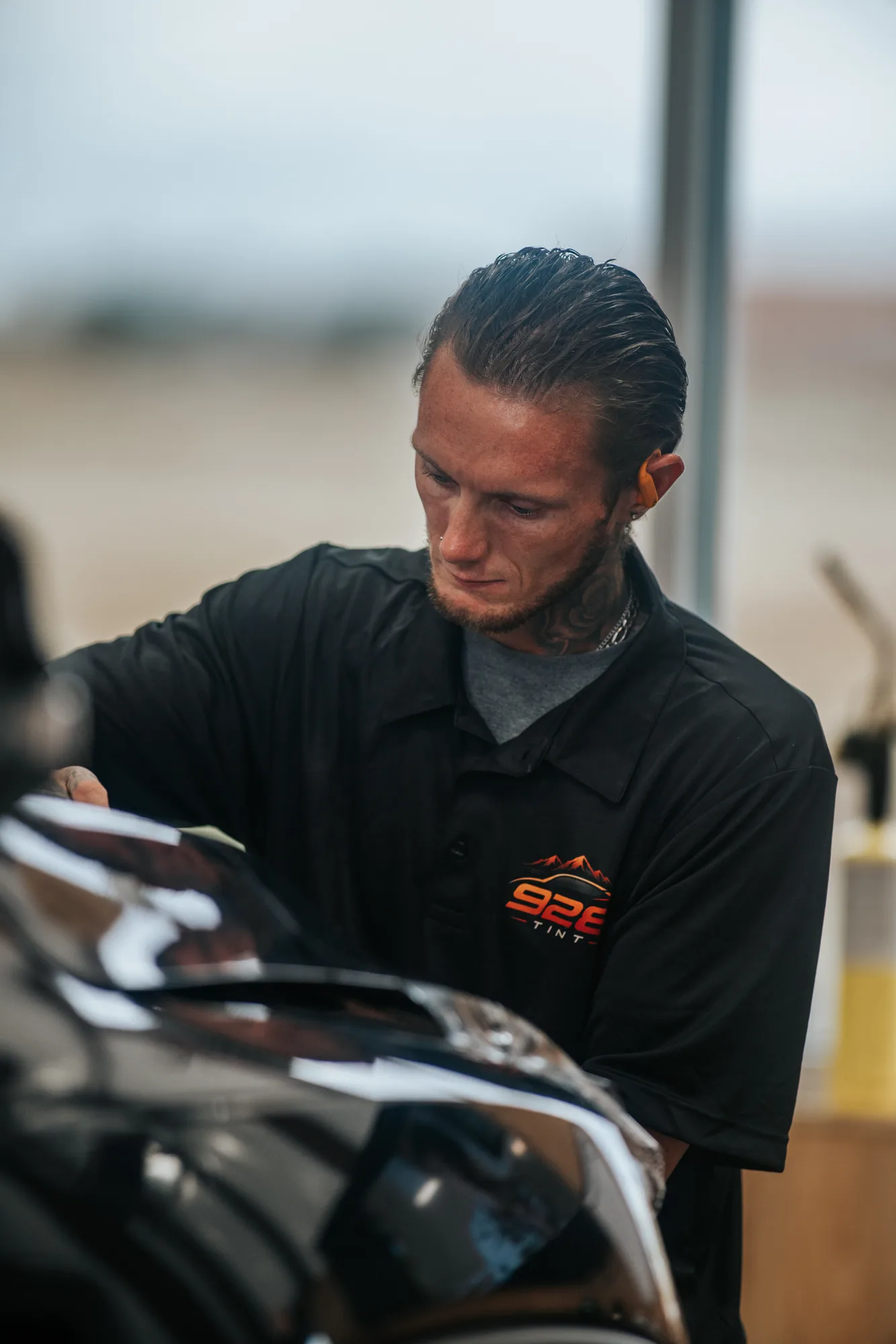 Installer at a truck hood, shot on the adapted Canon FD 300mm f/2.8 L
