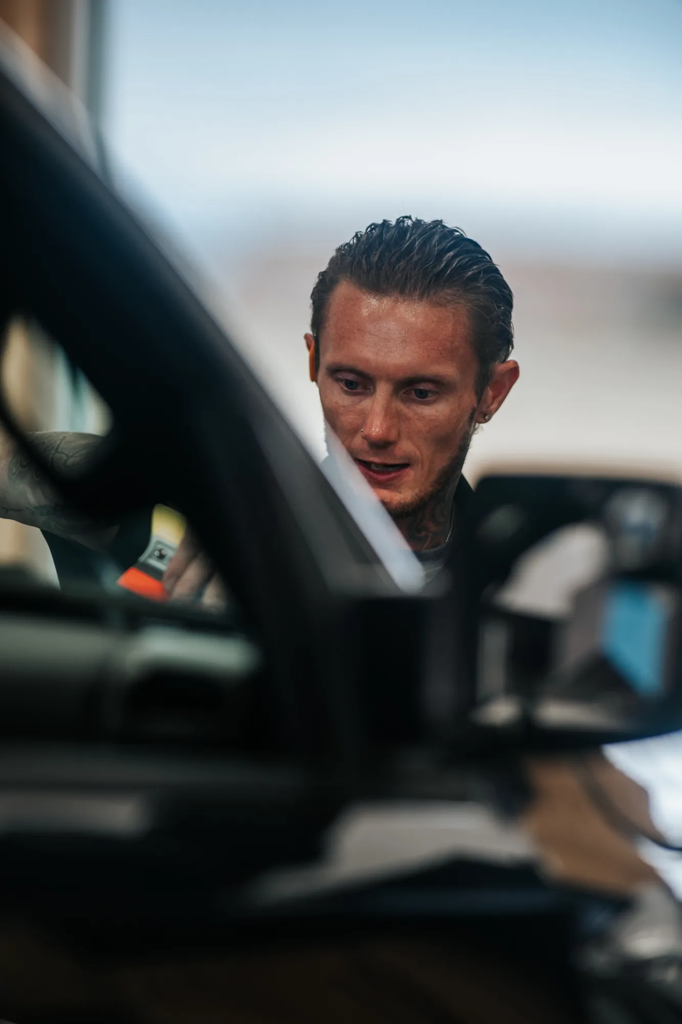 Installer's face caught in a truck mirror, Canon 300mm f/2.8 on a Sony A1