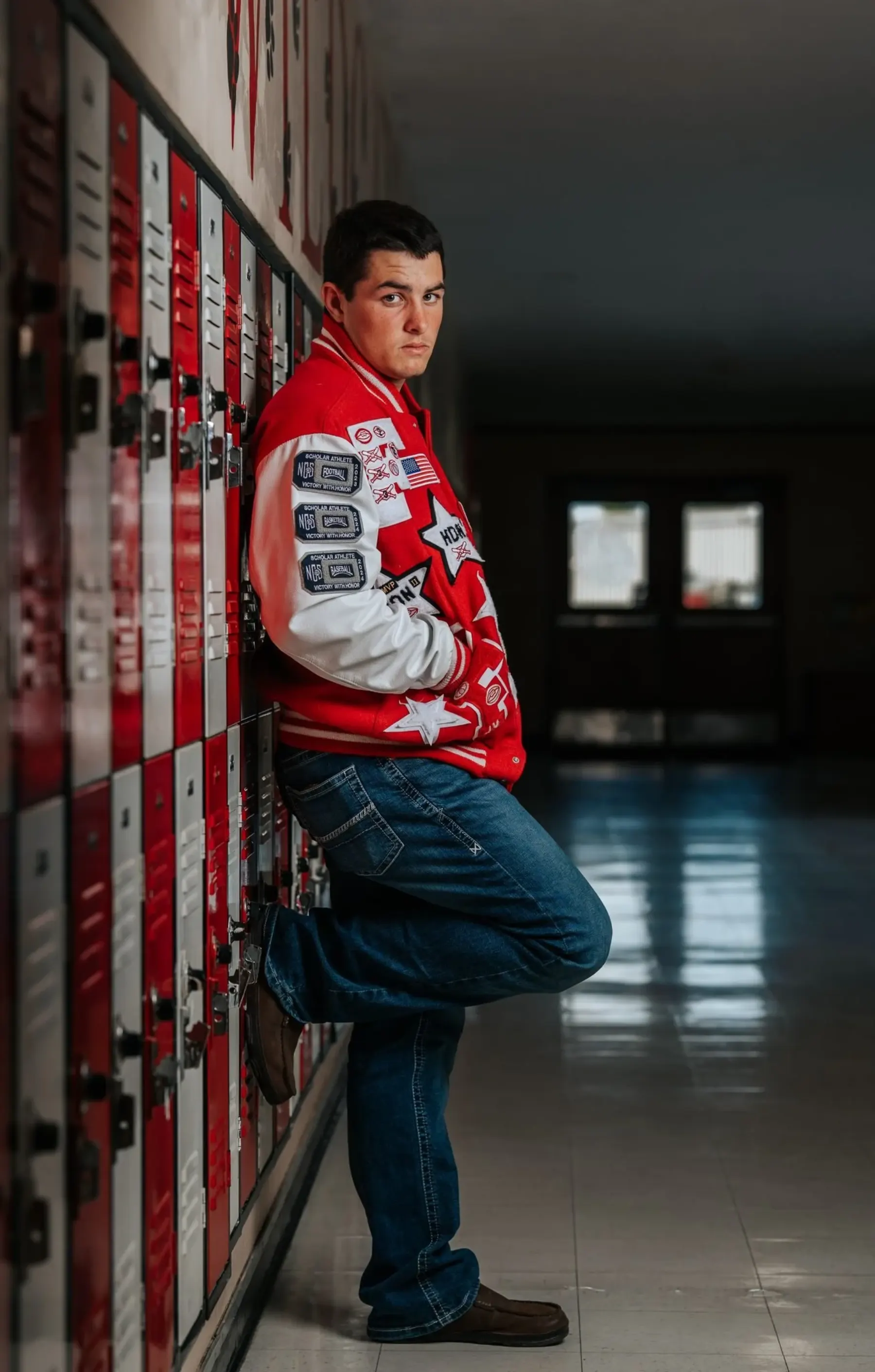Tanner Pidgeon leaning against school lockers during senior portrait session by Tex Kelly Productions