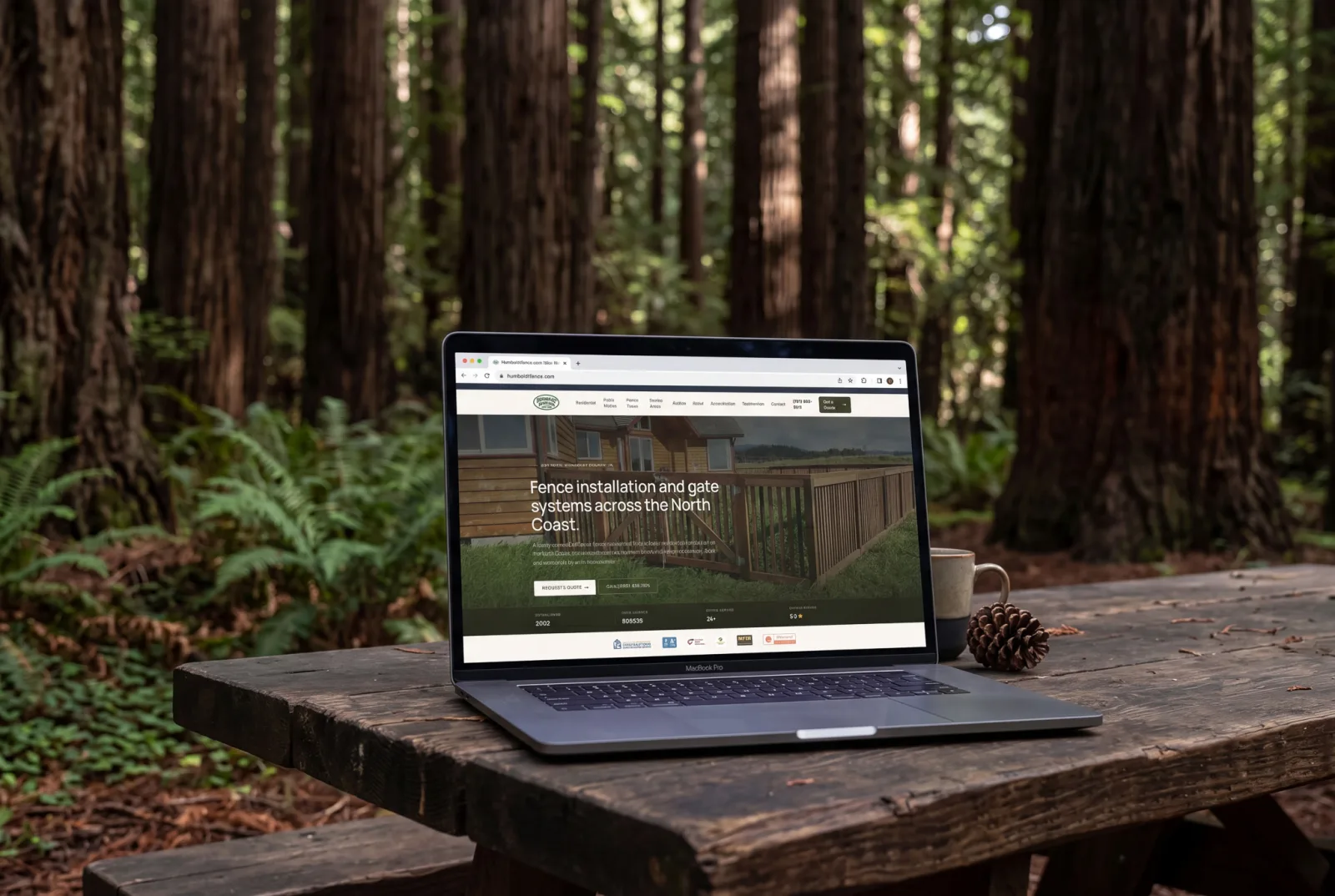 The Humboldt Fence Company website on a laptop in a Humboldt County redwood forest