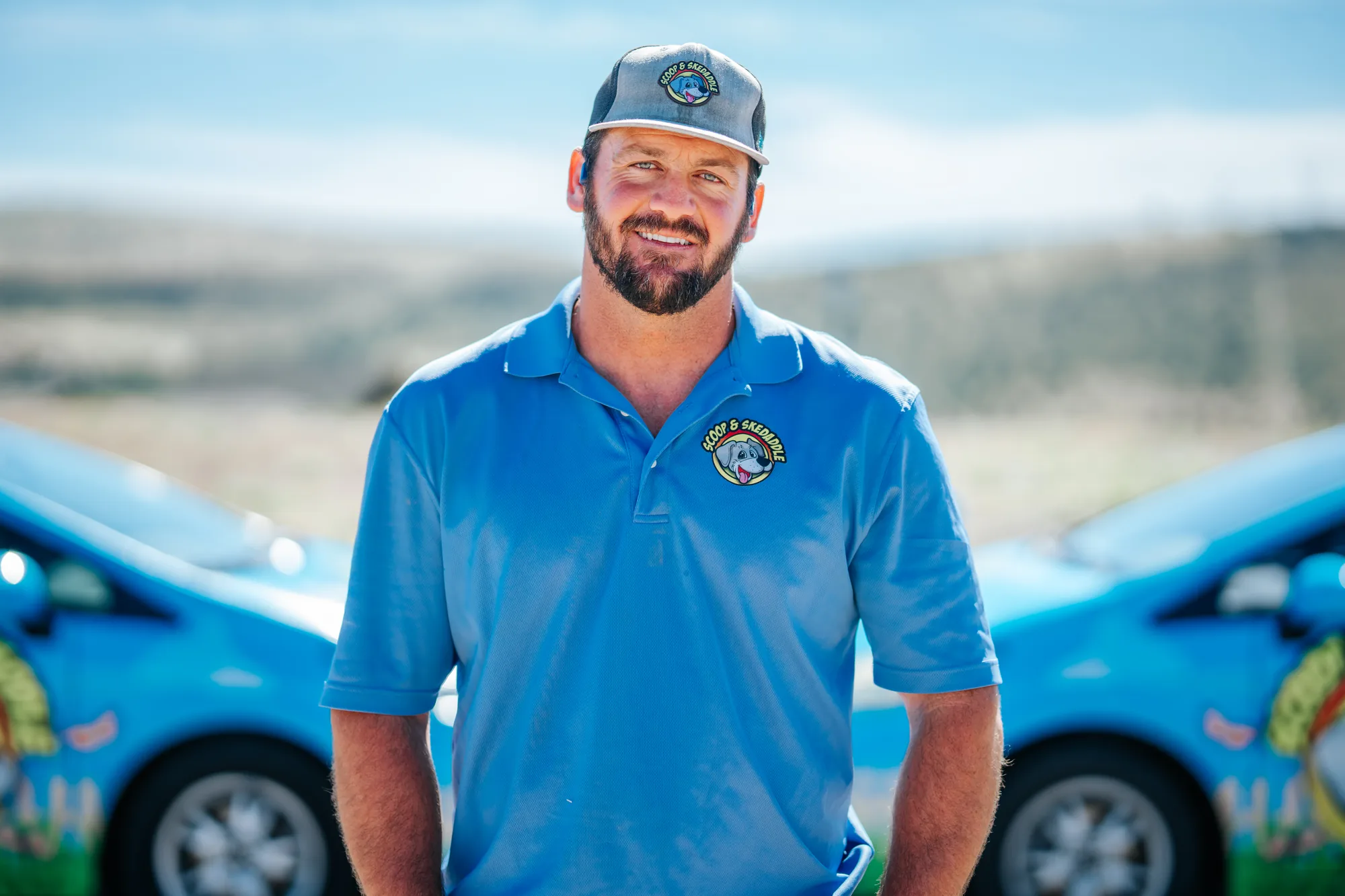 Brand headshot of a Scoop & Skedaddle team member in uniform
