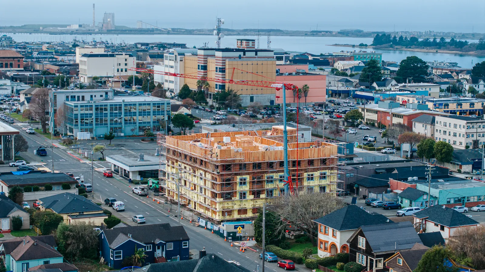 Construction-progress drone aerial of a mid-rise build with tower crane over downtown. Drone Photography and Videography by Tex Kelly Productions, serving Williams, Arizona.