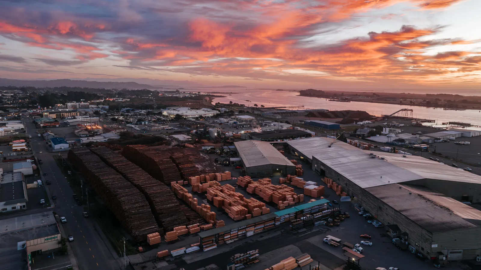Working lumber yard on Humboldt Bay at sunset, commercial drone aerial by Tex Kelly Productions. Drone Photography and Videography by Tex Kelly Productions, serving Williams, Arizona.