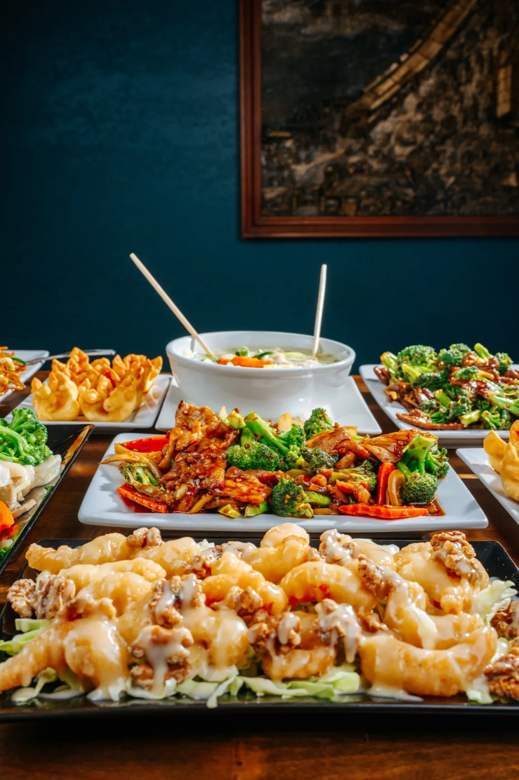 Hunan Chinese Restaurant, chopsticks holding a broccoli-beef bite over the plate, editorial close detail