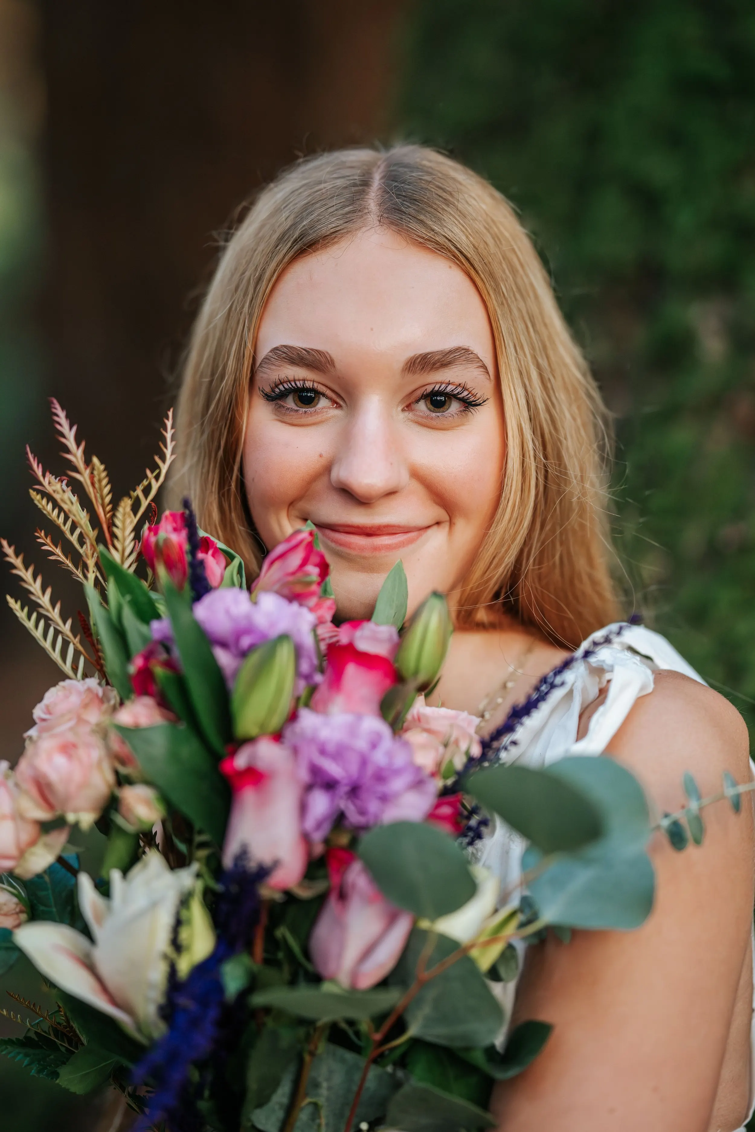 Senior portrait against backlit golden-hour grasses