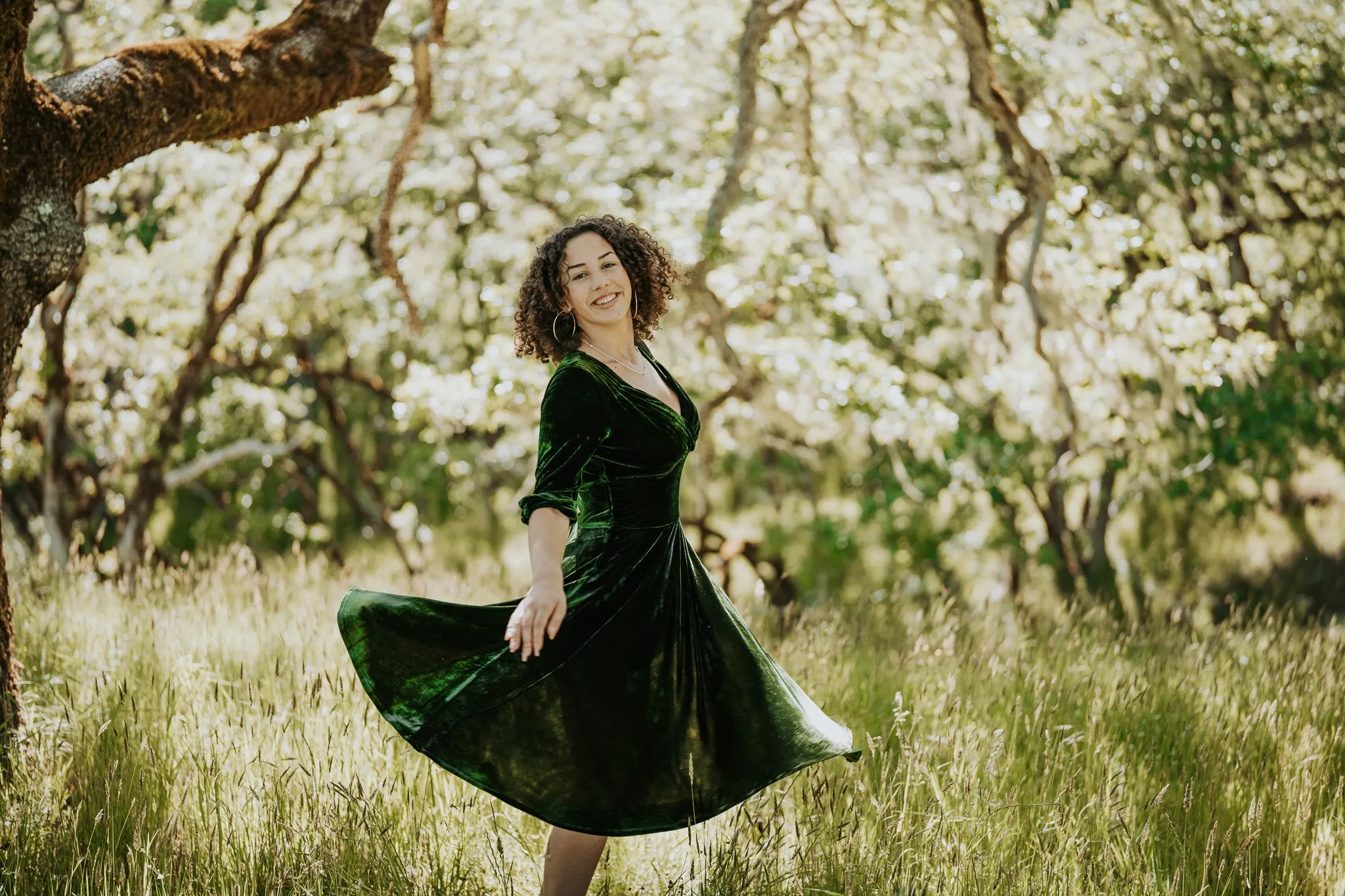 Open-shade editorial portrait against soft greenery