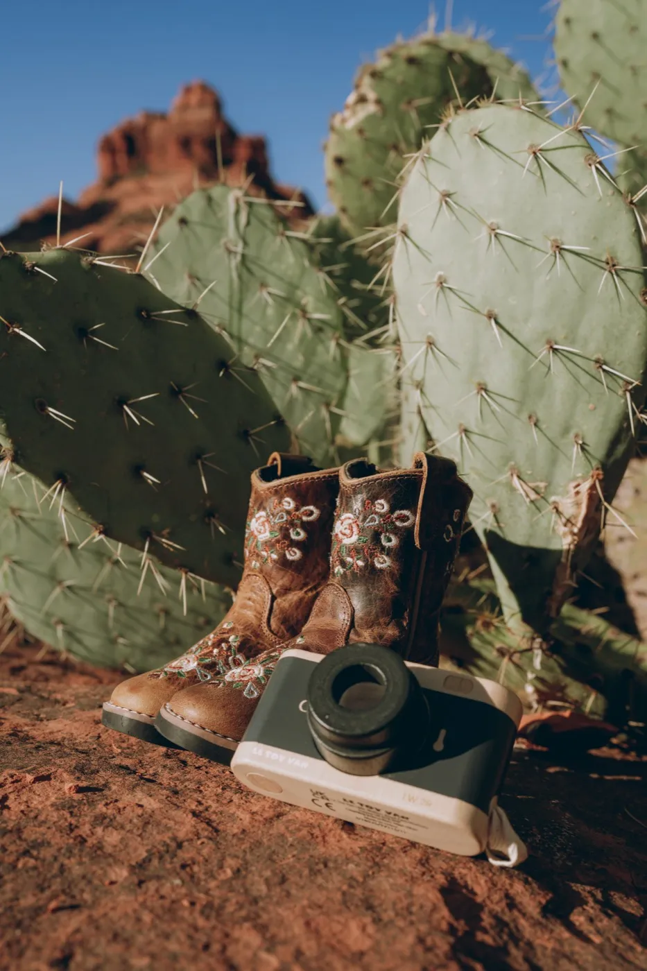 Tiny boots on the red rock for a Sedona baby announcement, photographed by Tex Kelly