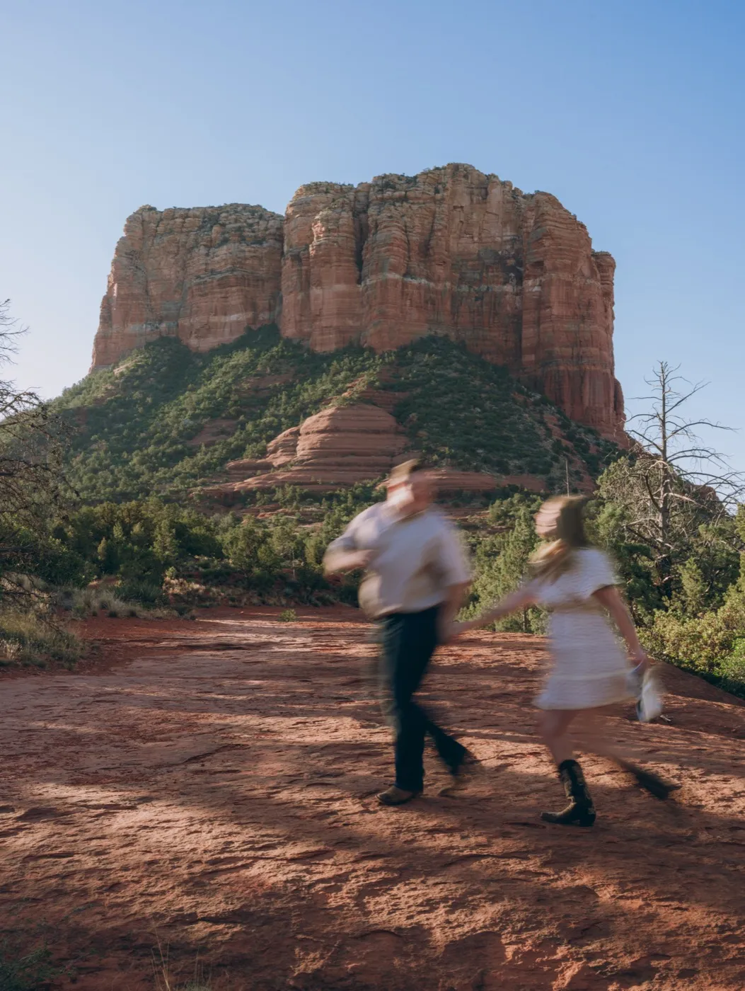 Pregnancy announcement session in Sedona, Arizona, couple walking the red rocks. Photography by Tex Kelly Productions, serving Sedona, Arizona.