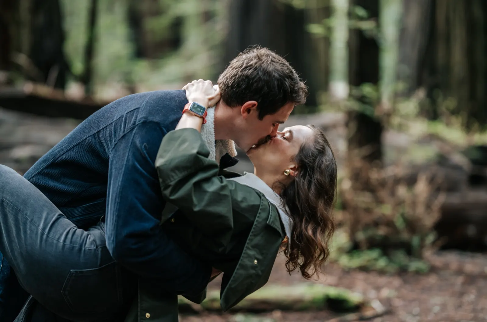 Chris kneeling for Erin in the redwoods