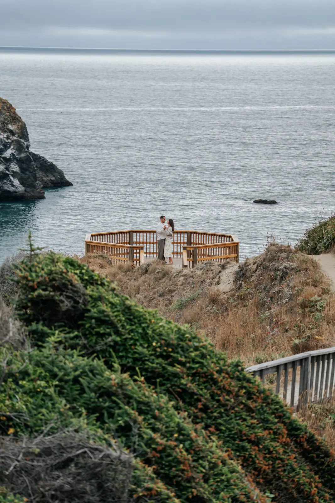 Olivia and Michael walking on a coastal bluff