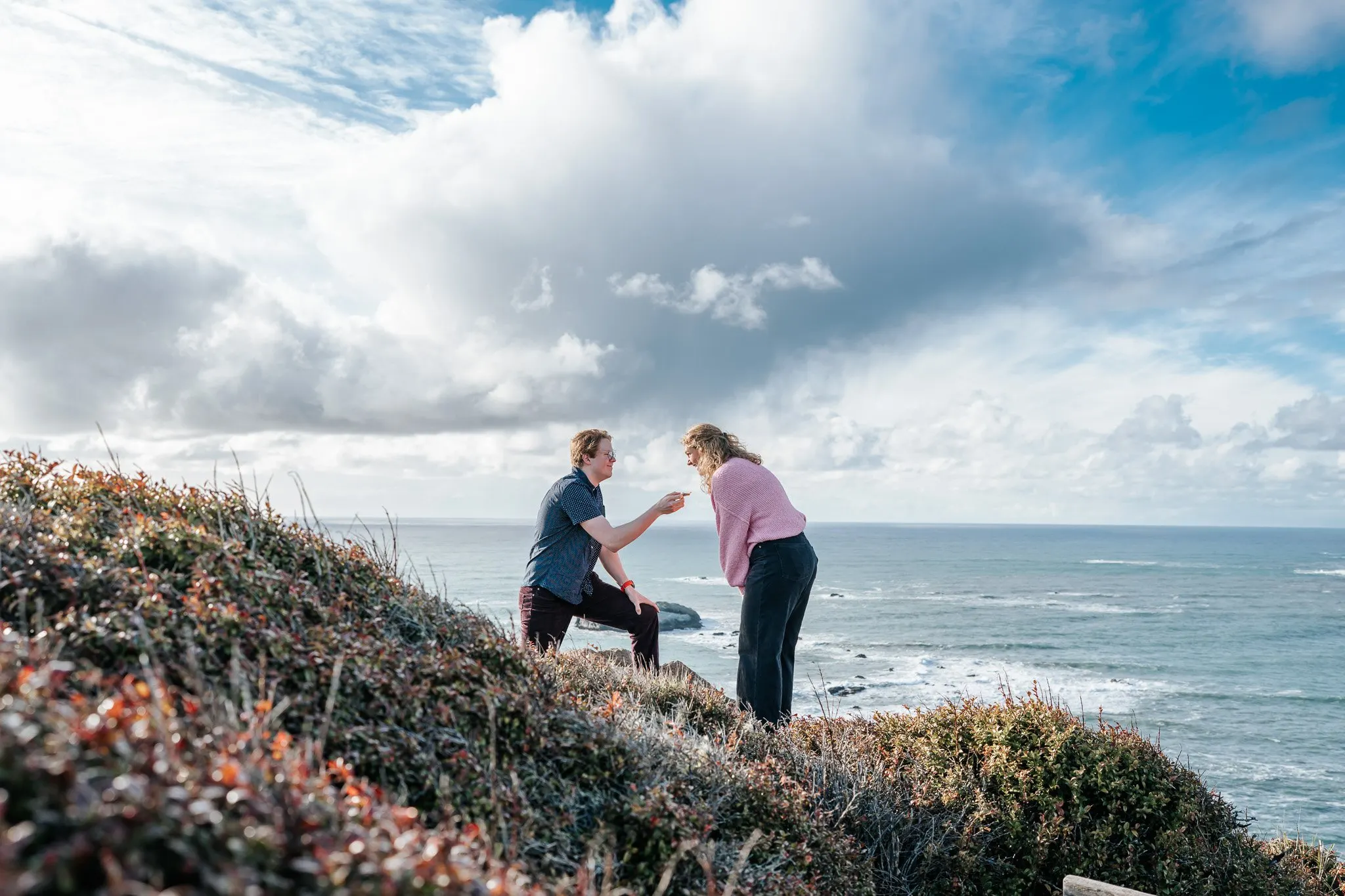 Couple embracing at sunset on a North Coast bluff