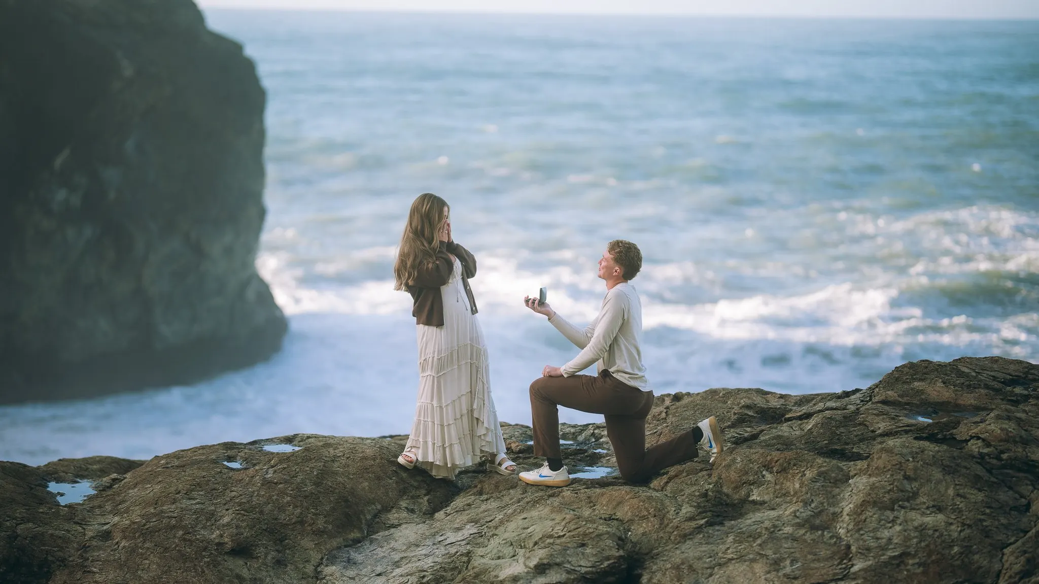 Couple portrait at the edge of a coastal cliff