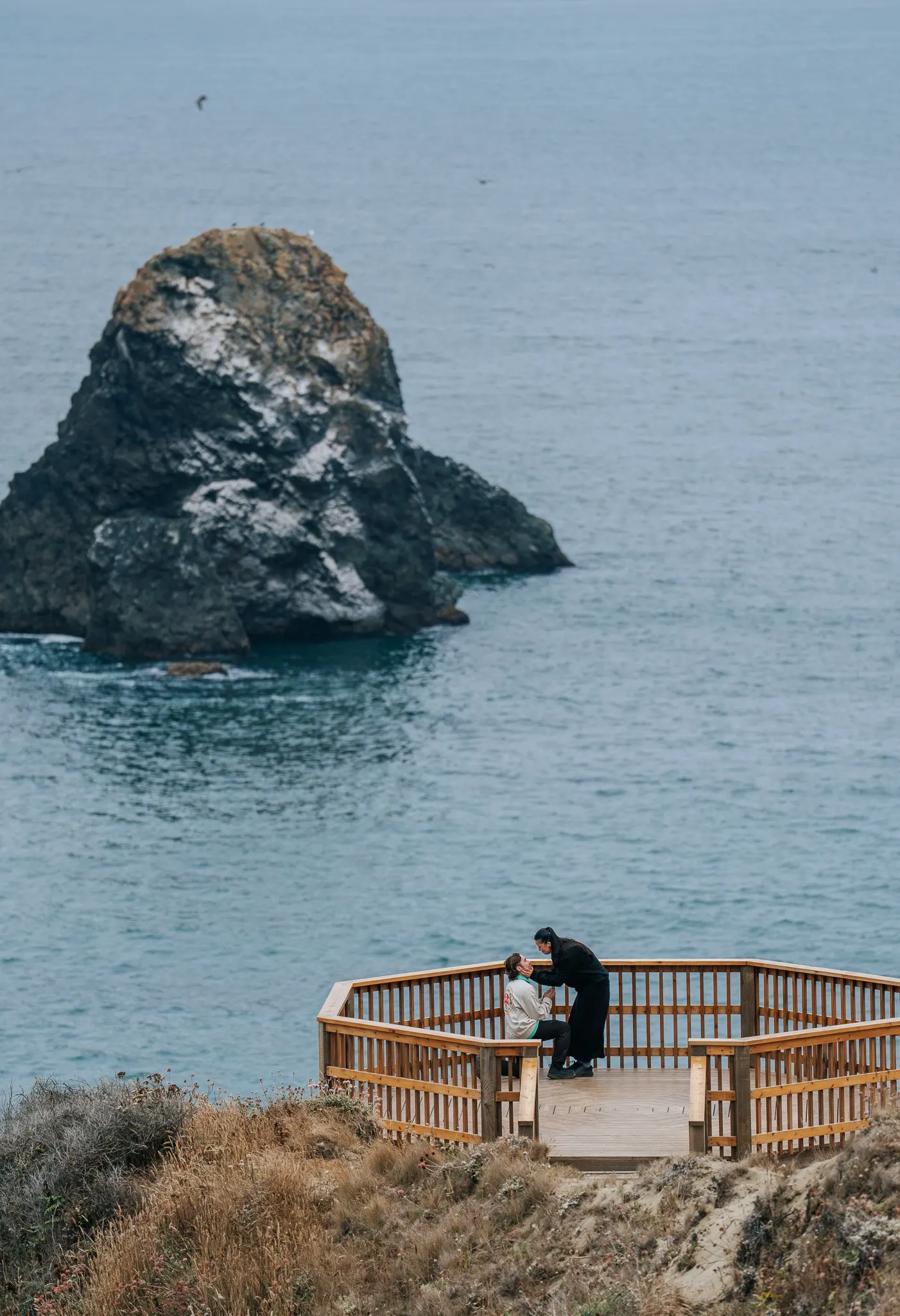 Couple silhouetted against the Pacific surf
