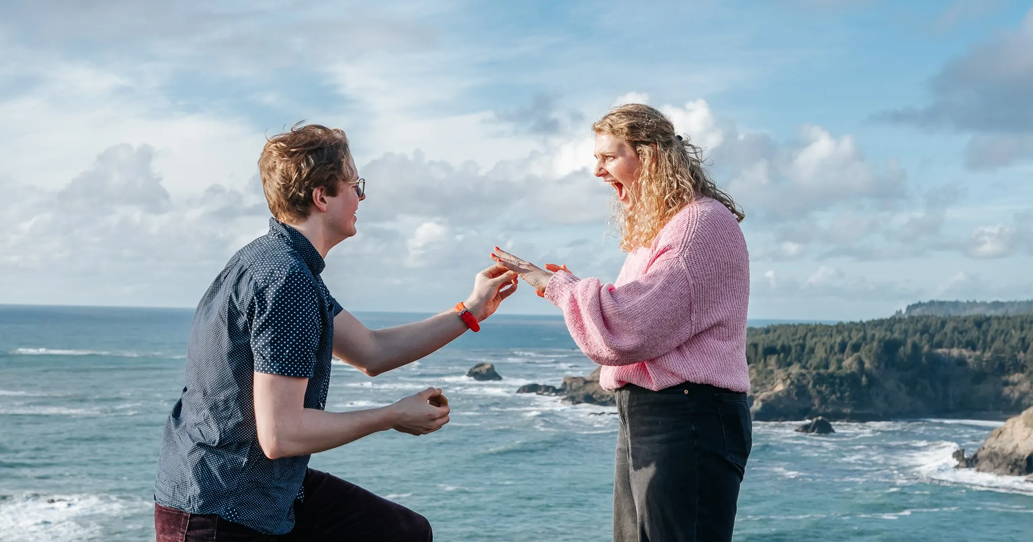 Couple on the Trinidad bluffs with sea stacks behind