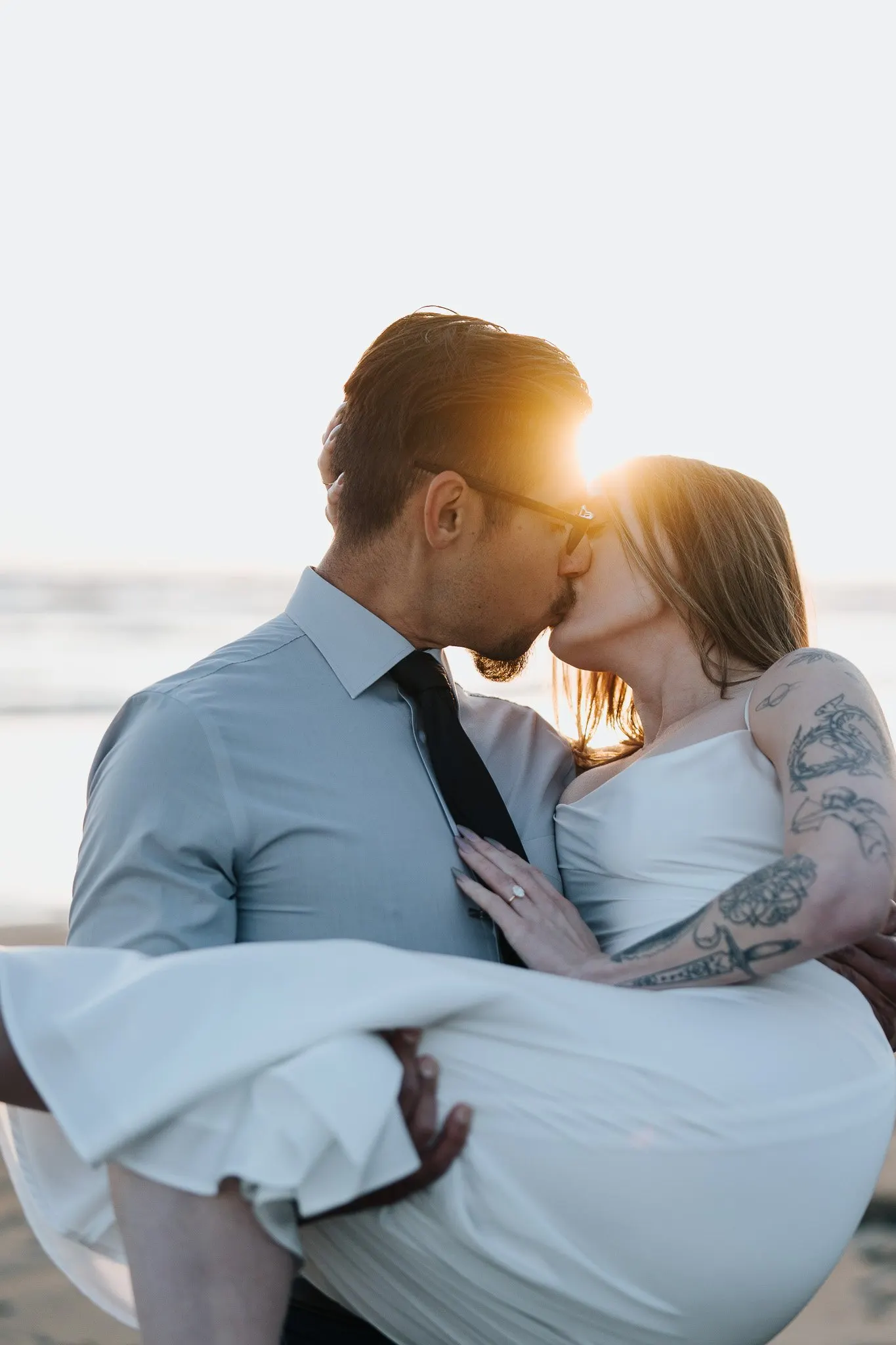 Couple silhouetted against a golden-hour sky