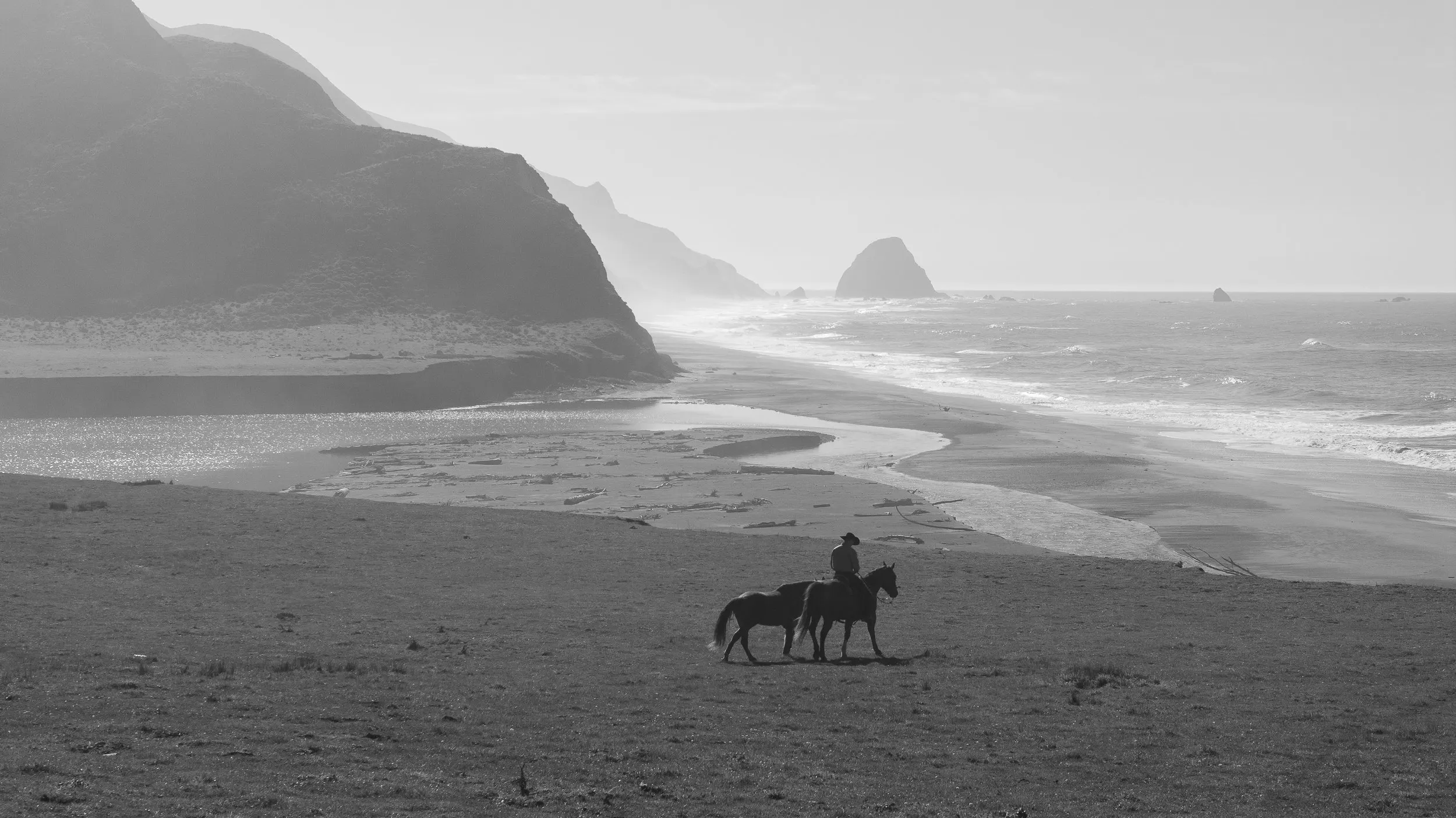 Aerial drone shot of a cowboy on horseback along the Humboldt County coast. Tex Kelly Productions senior portraits