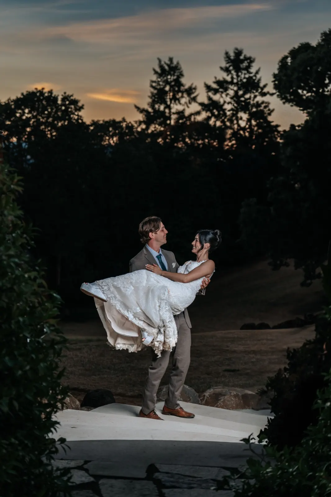 Rose and Charles, groom carrying bride at sunset
