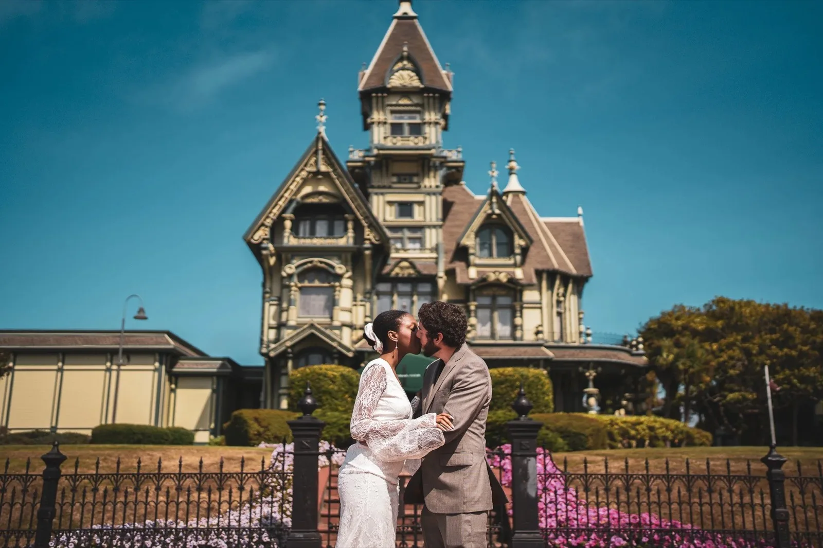 Newlyweds kissing in front of the Ferndale Ingomar Theatre. Humboldt County Victorian wedding photography