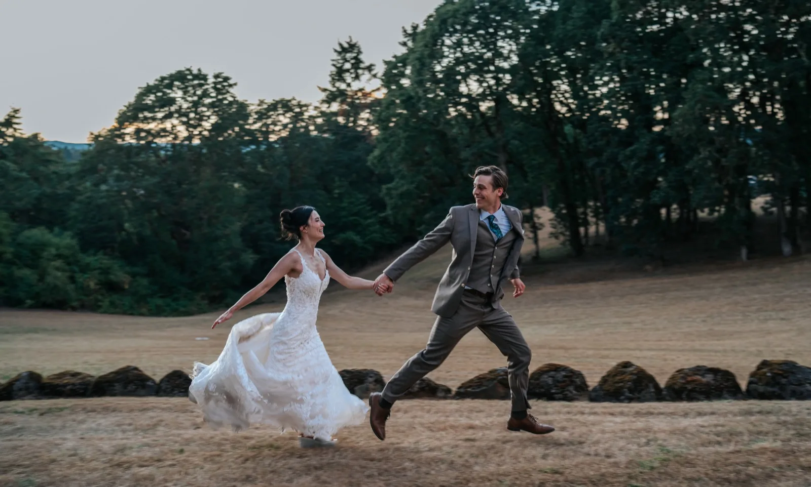 Bride and groom first dance in a golden-hour field