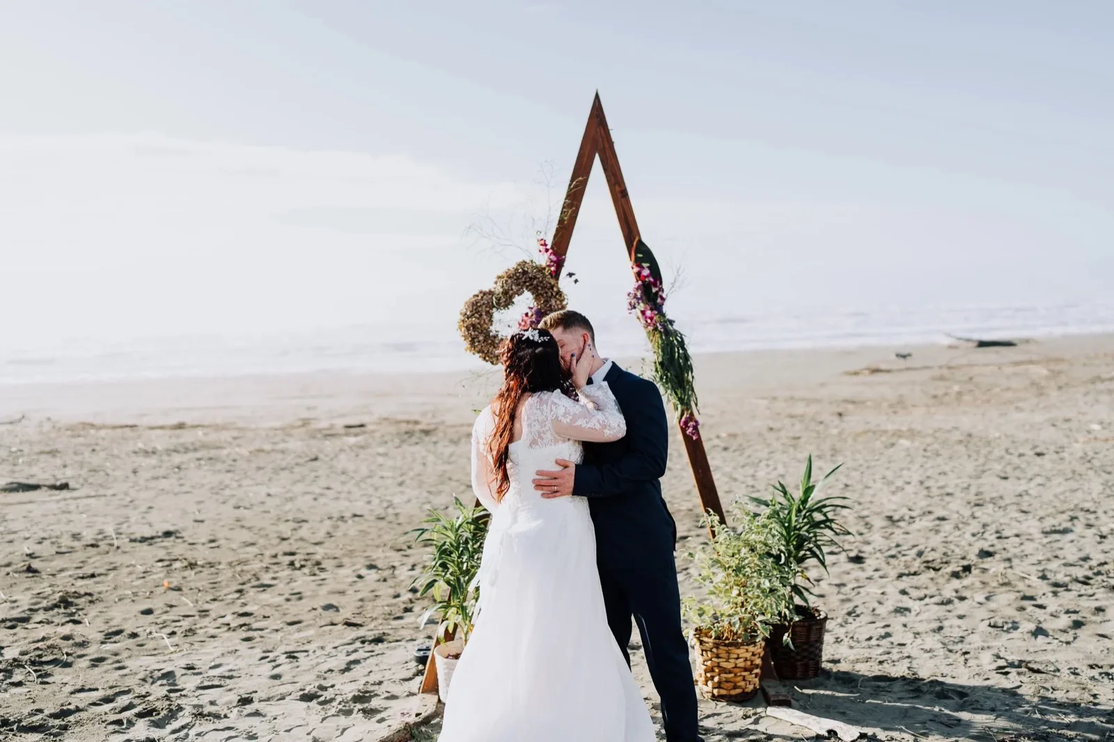 Couple on the beach at Trinidad with the redwoods behind. North Coast destination wedding
